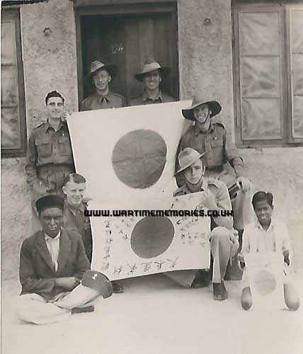 Fred Wearden and pals in Burma with a Japanese Flag