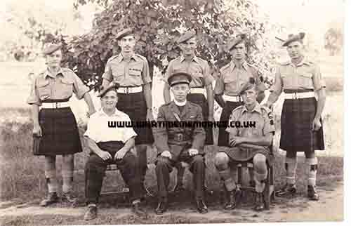 Back row: Pte Scott, 1 ivanhoe Cresc., Wishaw; D. Murray, Shotts; Pte Brown, 23 Vere Rd., Blackwood; H. O'Shea, 118A Cadzow St., Hamilton; (1 soldier unidentified). Front row: Cpl. Bruce P(?), 6c Manse Ave., Old Monkland, Coatbridge; Capt. George B Urquhart, Larkhall; Pte George Nisbett, 9 Burnblea St., Hamilton. Possibly in India 1946