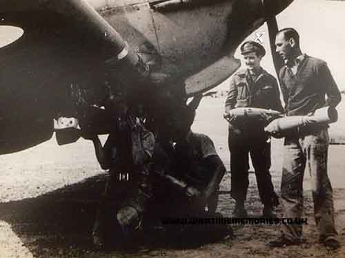 George Sim in uniform helping to arm a spitfire from 80sqd