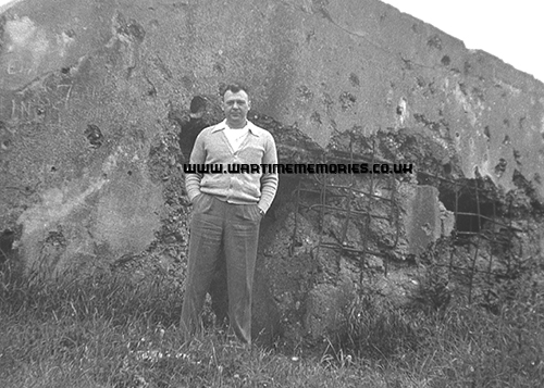 Louis Saites during a post-war visit to France, Louis standing in front of the bunker where he was captured in Nancy.
